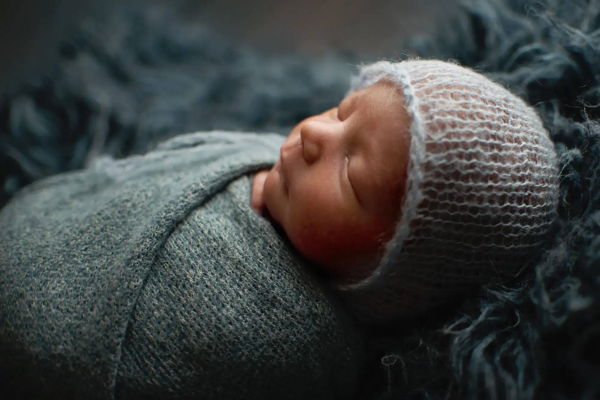 Newborn baby swaddled and sleeping